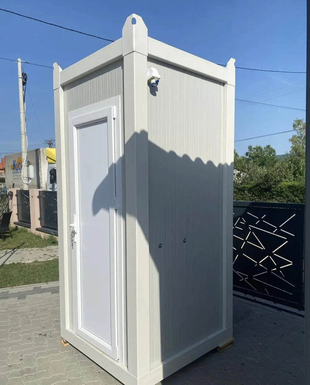 White deluxe flushing portable toilet with a hinged door