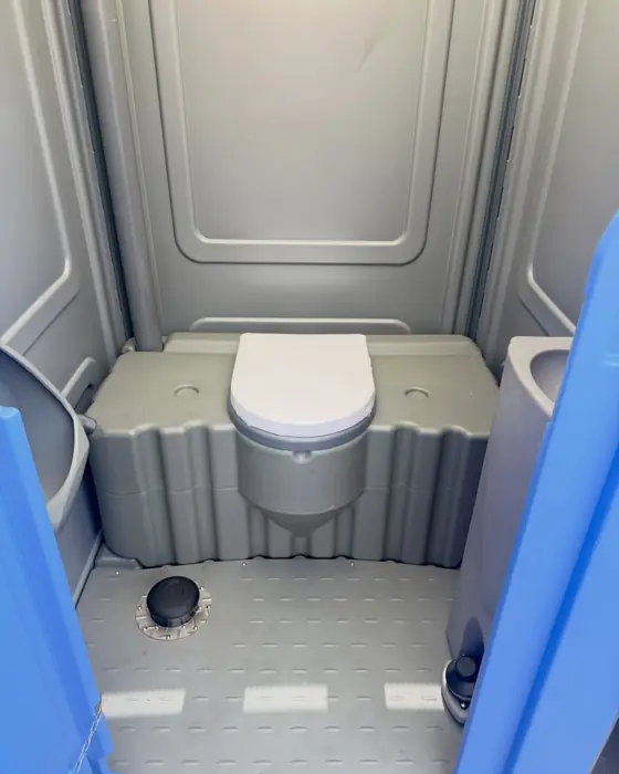 Roomy porta potty interior with low seat