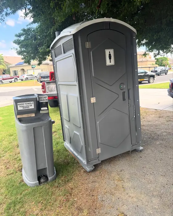 Porta potty with a two-sink hand-washing station